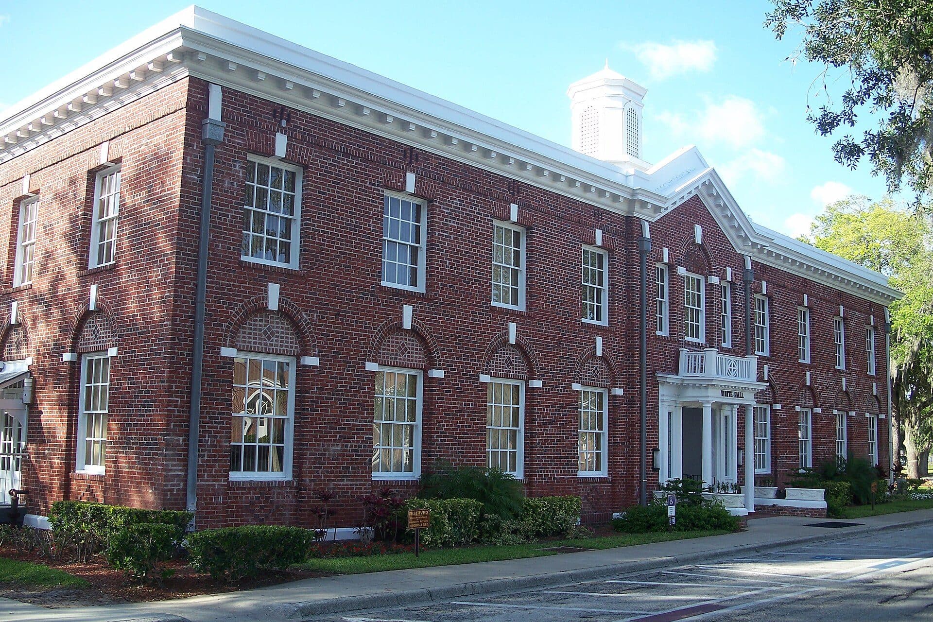 White Hall, a two-story red-brick building with white trim, on the Bethune-Cookman campus under a blue sky