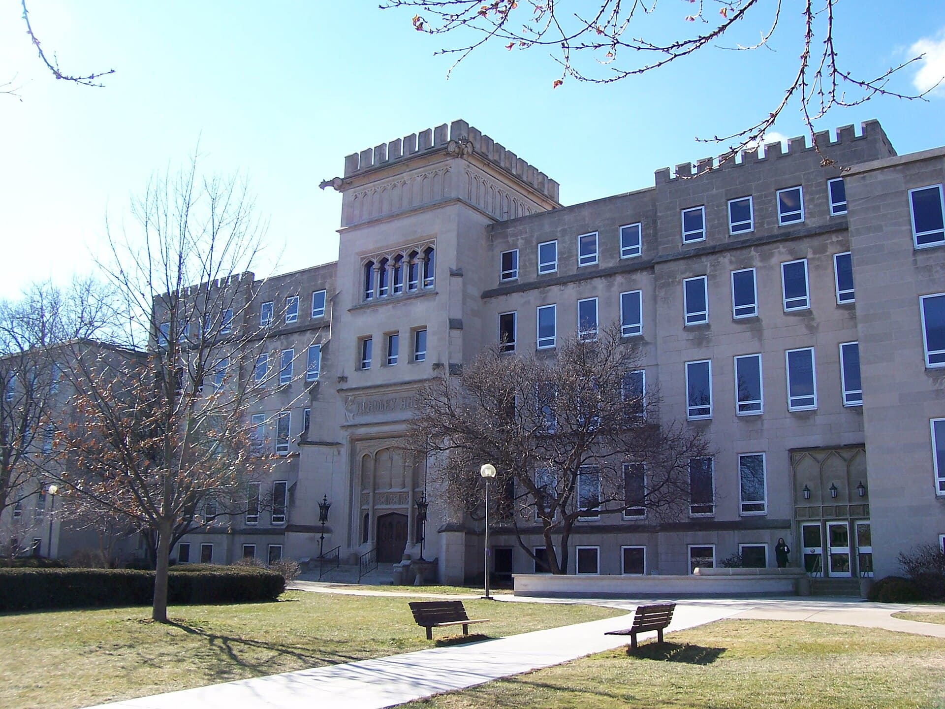 Bradley Hall, a stone building with castle-style battlements and arched windows, on a winter day at Bradley University in Peoria