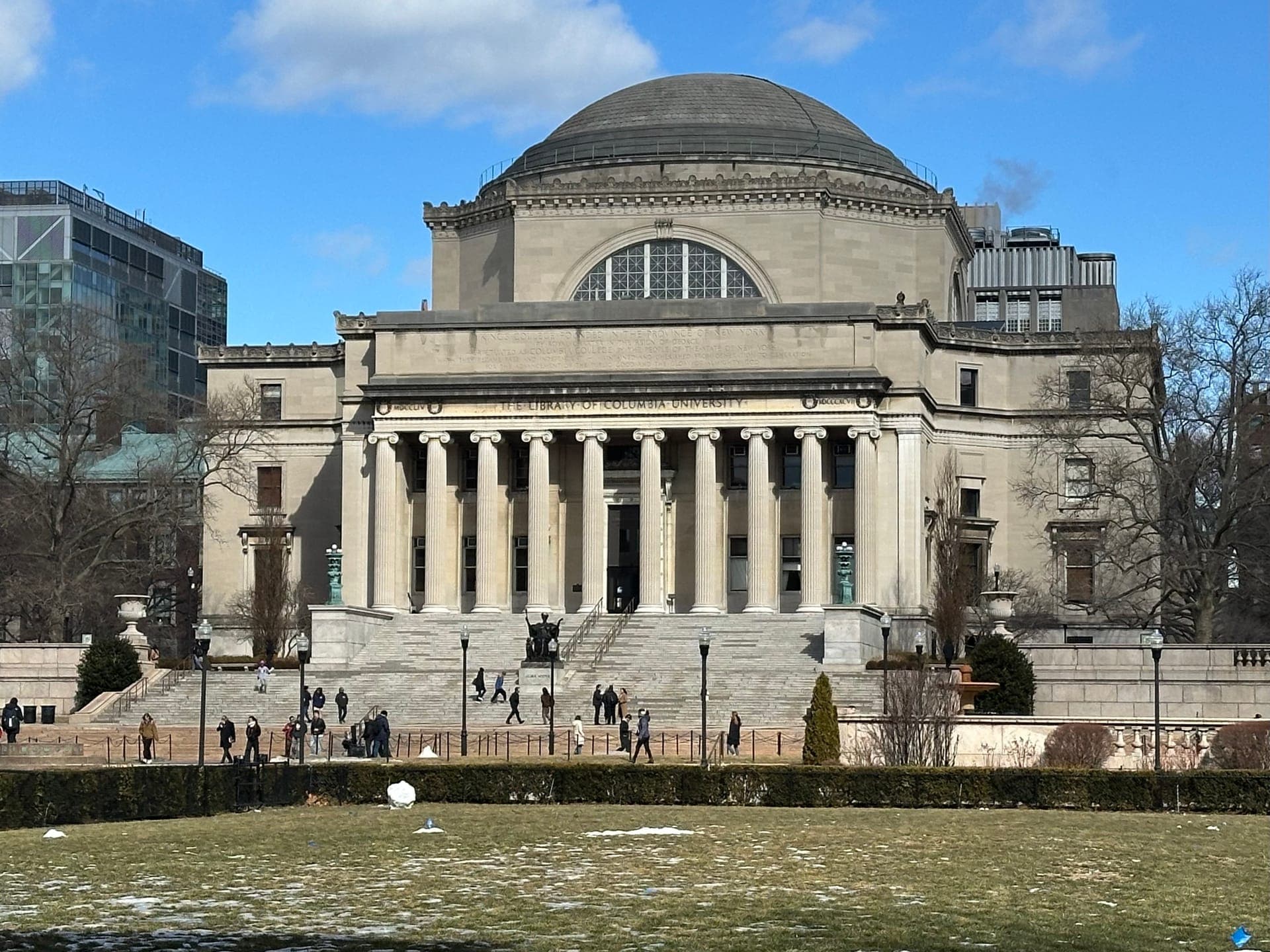 Low Memorial Library at Columbia, a domed neoclassical building with a columned portico above wide steps and a lawn, on a sunny winter day