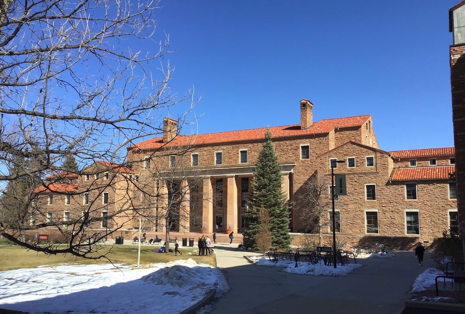 The north side of Norlin Library at CU Boulder, a sandstone building with a red tile roof