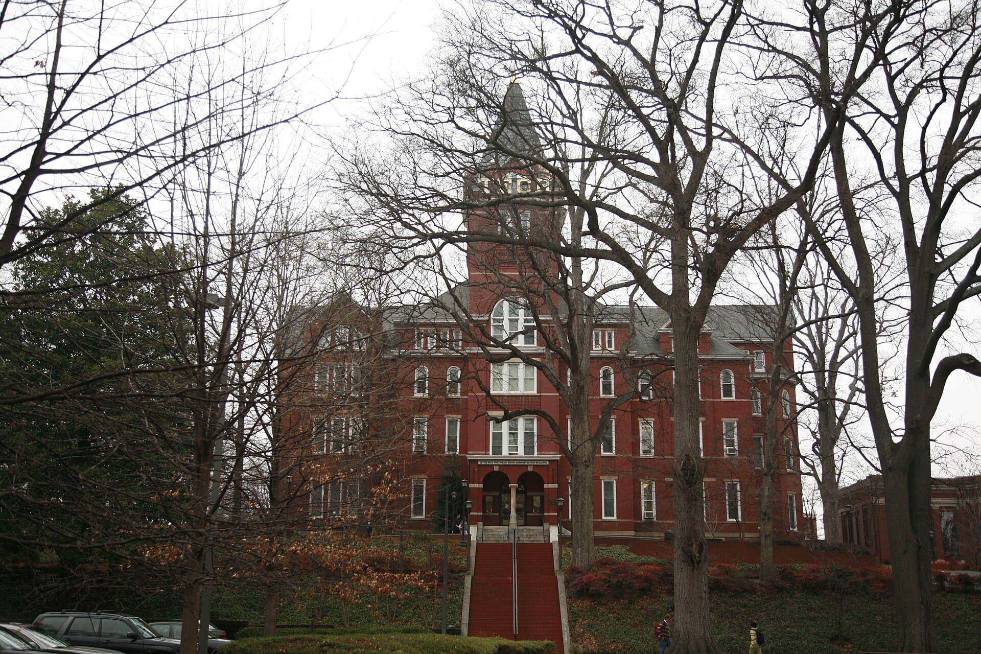 Georgia Tech's red-brick Tech Tower administration building with its tall central tower, seen through bare winter trees