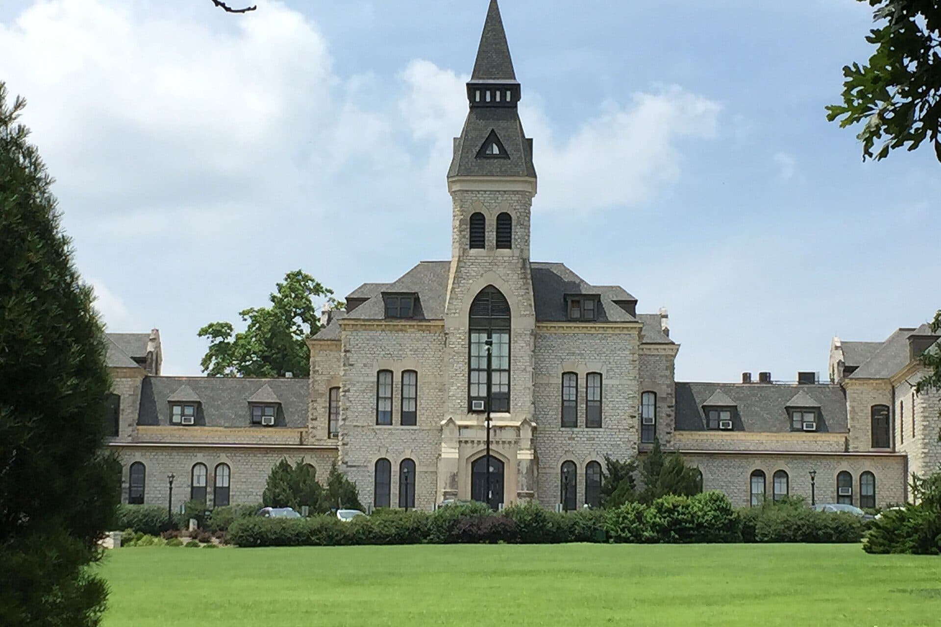Anderson Hall, a limestone building with a central tower, on the Kansas State University campus in Manhattan
