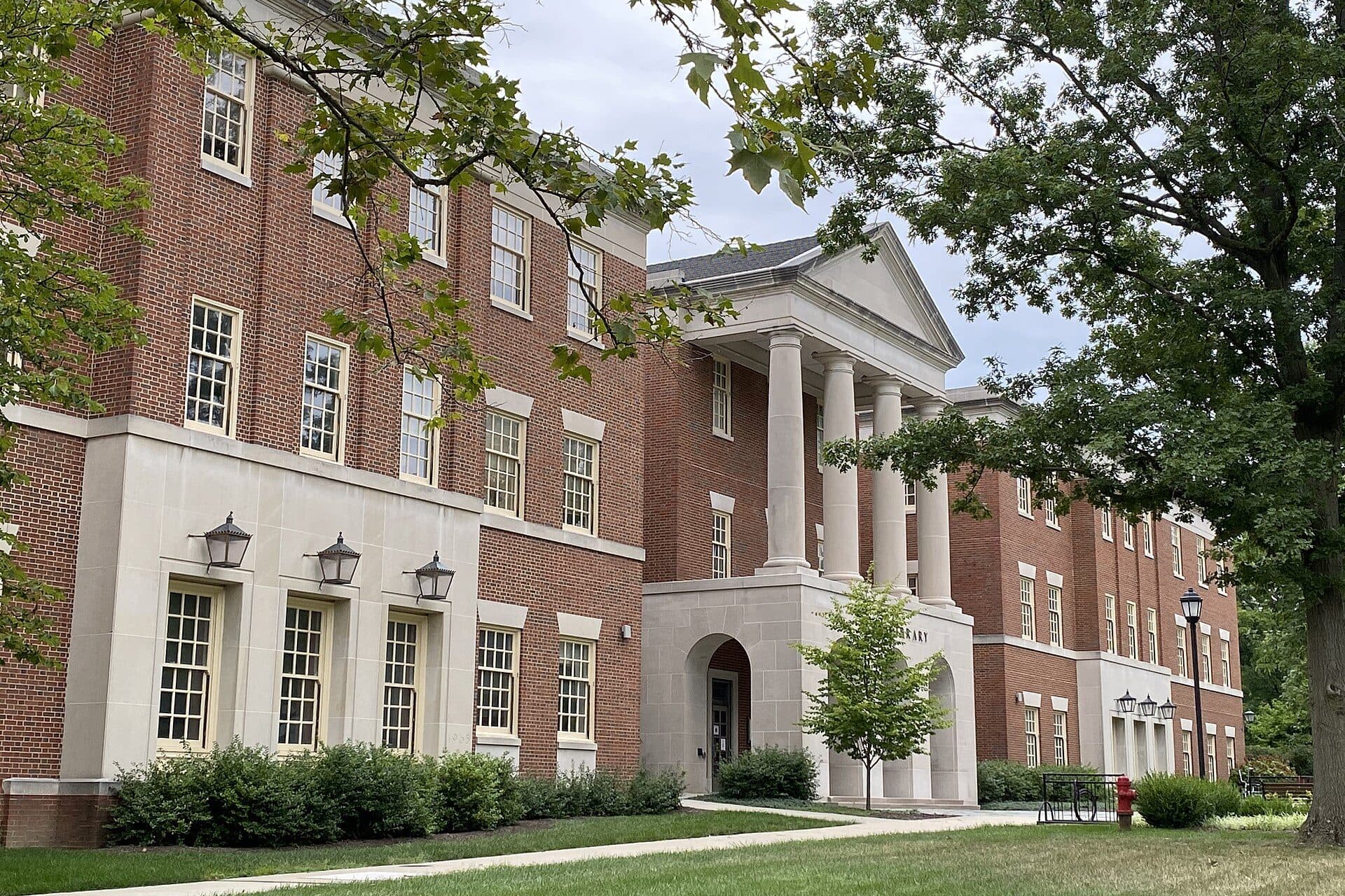 The red-brick and white-columned King Library at Miami University in Oxford, framed by trees and a green lawn