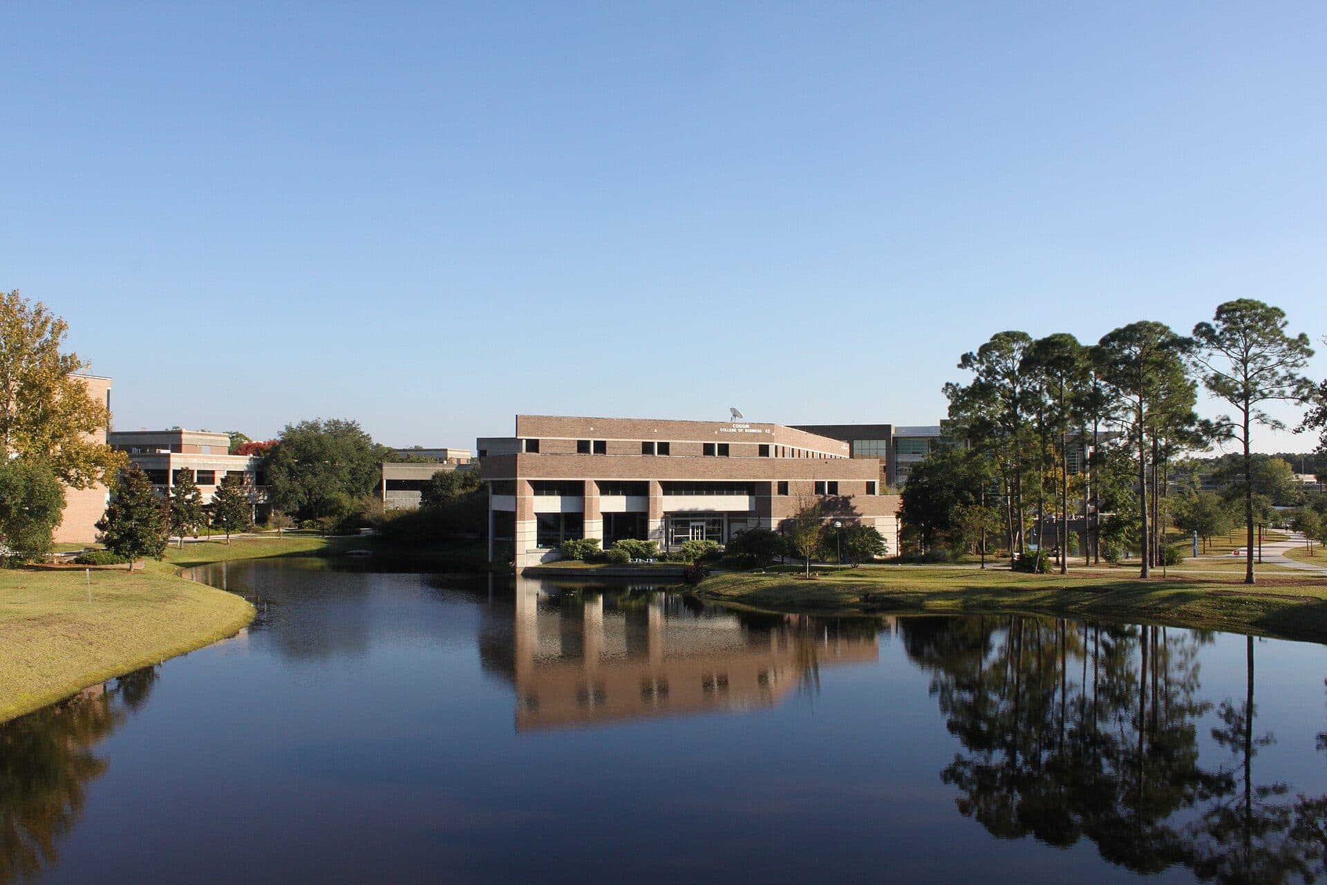 The Coggin College of Business building at the University of North Florida seen across a campus lake