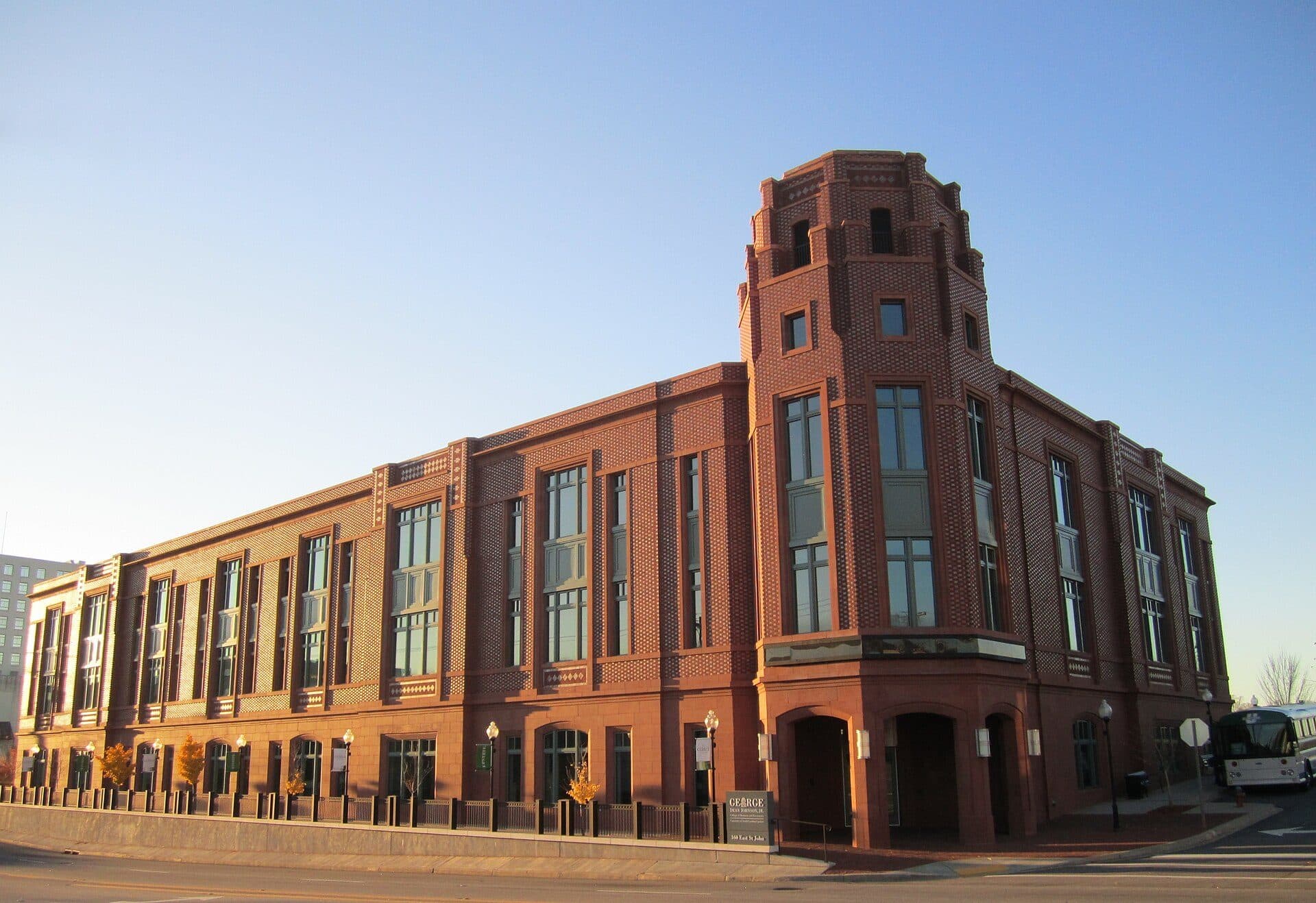 The red-brick George Dean Johnson, Jr. College of Business and Economics building on a downtown Spartanburg corner under a blue sky