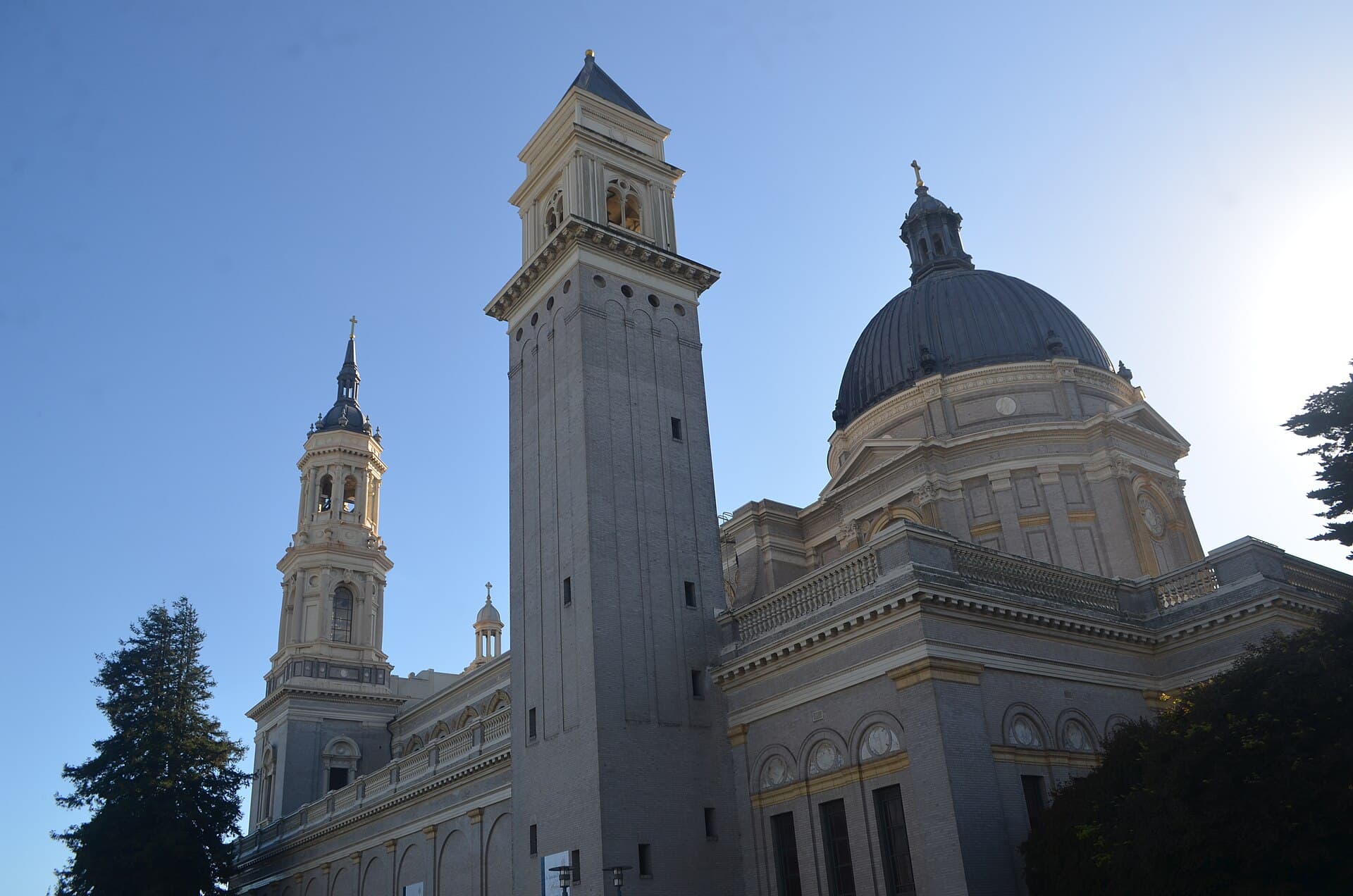 The twin bell towers and dome of Saint Ignatius Church on the University of San Francisco campus against a blue sky